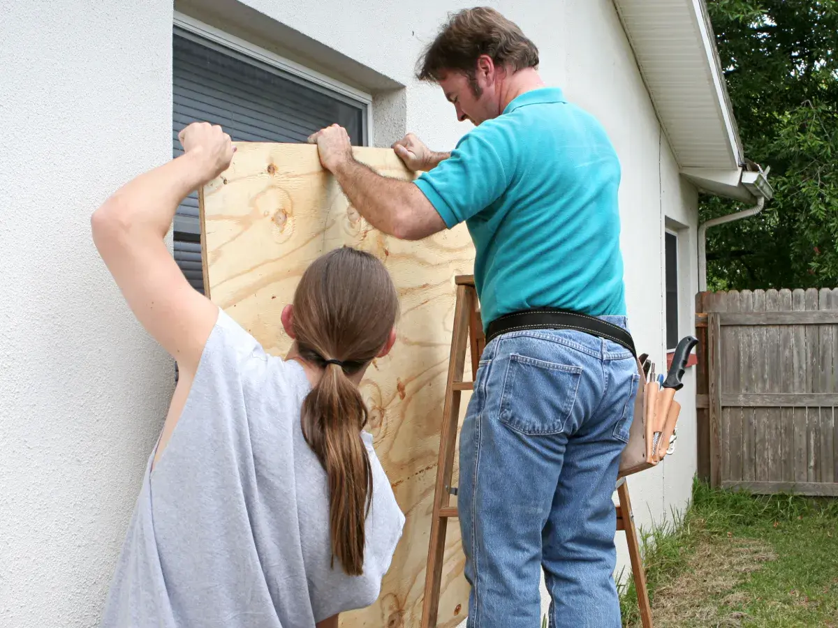 Hanging plywood over windows