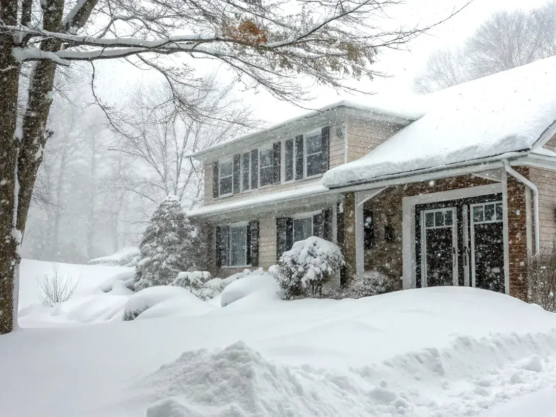 Front view of a home in a snow storm